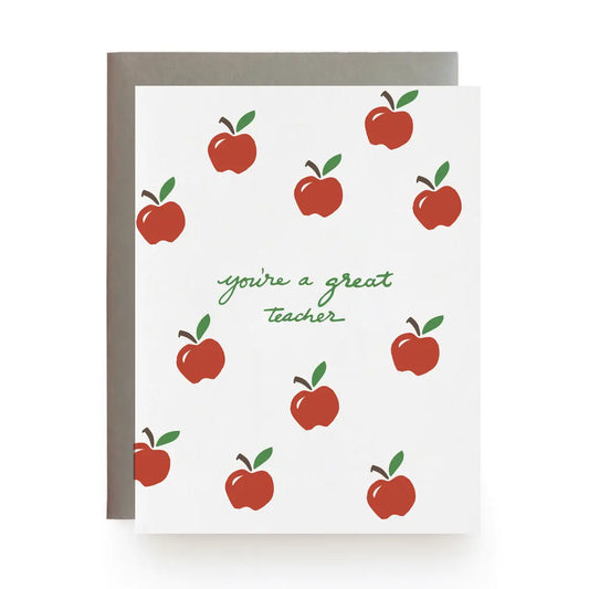 Greeting card with red apples and 'you're a great teacher' text in green on a white background