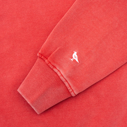 Close-up of a red sweatshirt with a small white Just Brand Seagull on a matching red background