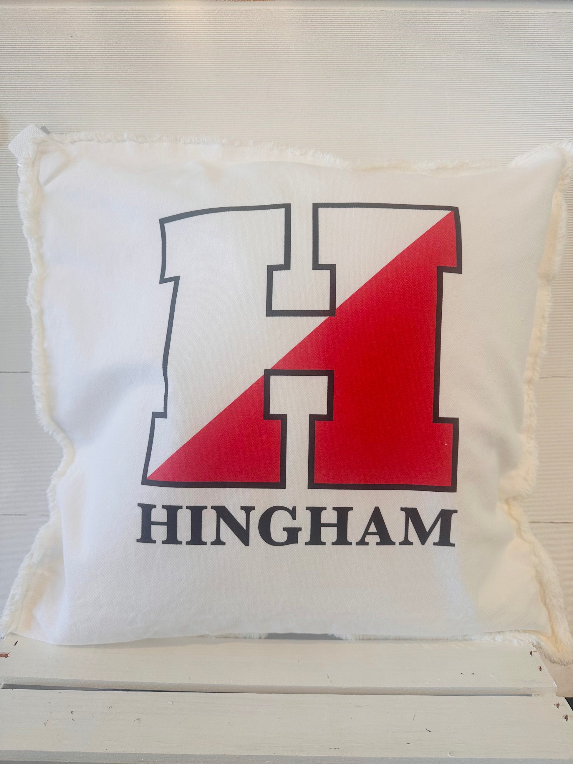 White Square Pillow with Hingham 'H' Logo in Red/Black.  Hingham written under Logo
