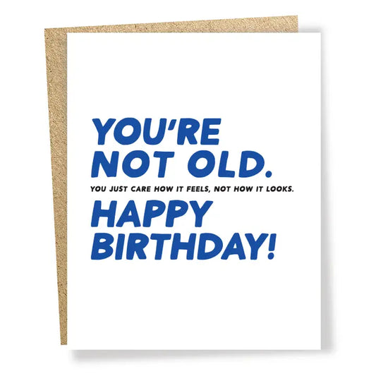 Birthday card with blue text that reads ' You're not old.  You just care how it looks.  Happy Birthday.' on a white background   