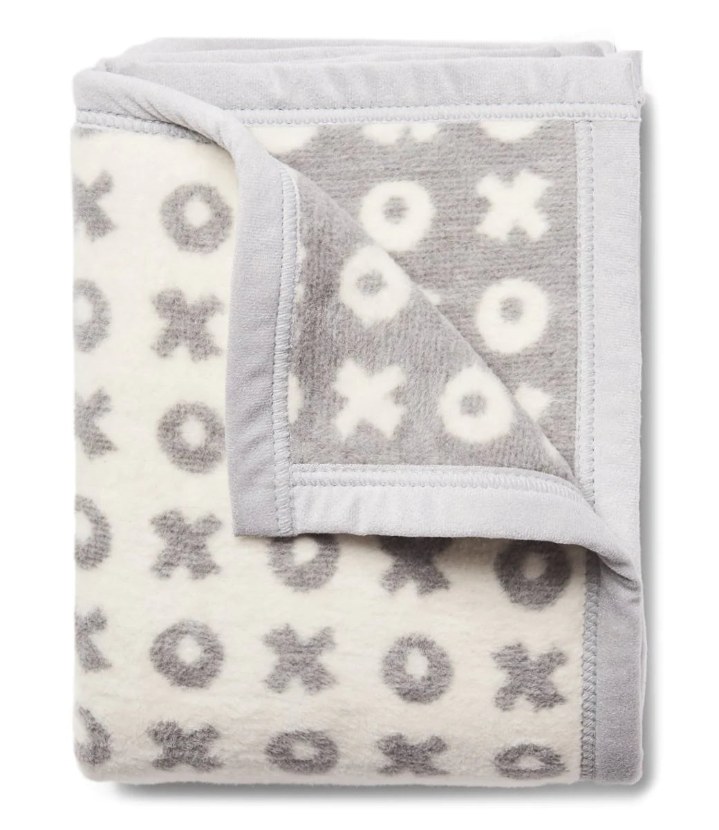 Gray and White folded blanket with x's and o's 