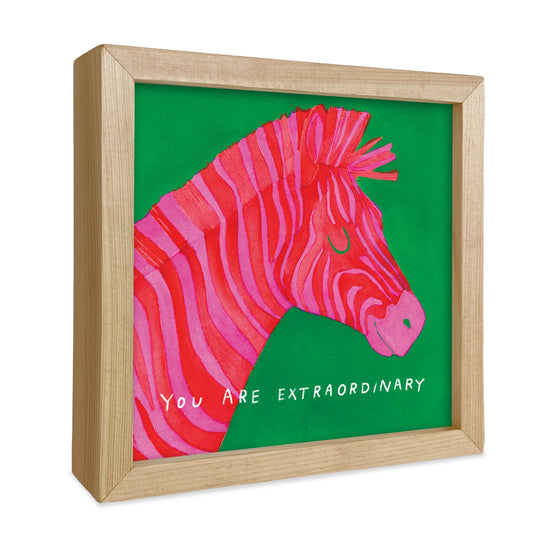 square framed hot pink zebra with green background.  words- you are extraordinary