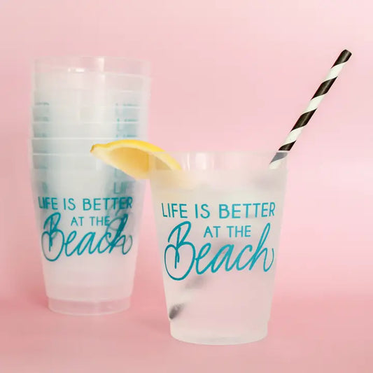 Clear cup with teal cursive writing