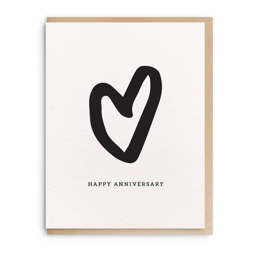white anniversary card that has a black heart in the middle with black writing under it that says "Happy anniversary".