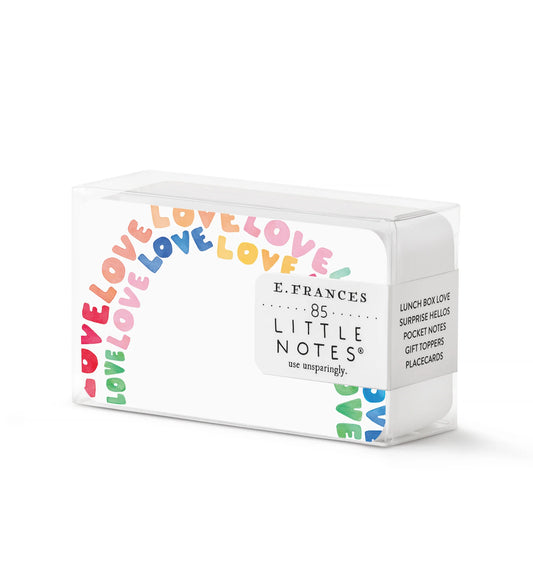 White little notes with love written in the shape and colors of a rainbow.