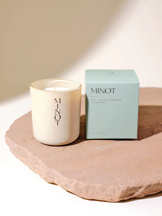 Minot tan candle with a light green box