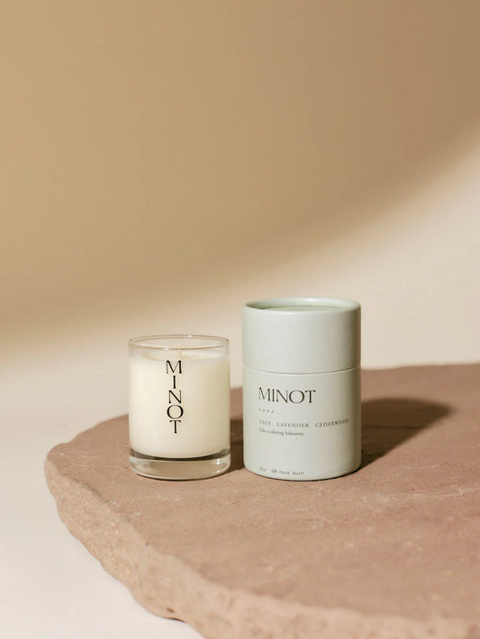 Mini Minot tan candle with white case on outside 