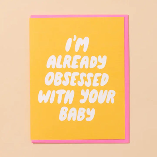 Yellow card with pink envelope and white text that reads "I'm Already Obsessed With Your Baby"