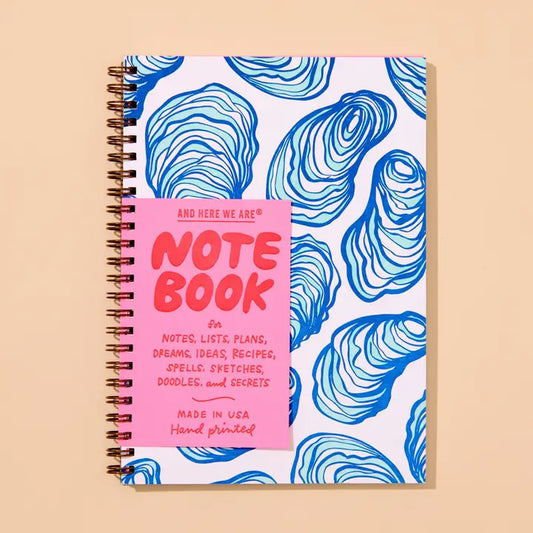 Spiral notebook with blue and white oyster shell pattern.