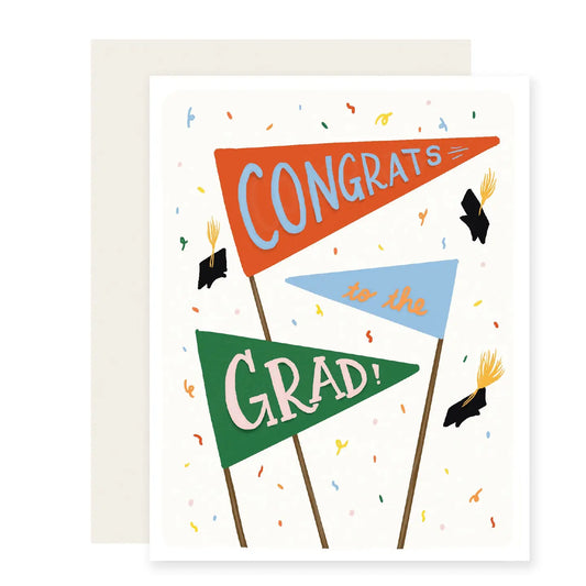 Graduation-themed greeting card with 3 colorful pennants with writing on each that read "congrats to the grad" and 3 falling graduation caps and confetti