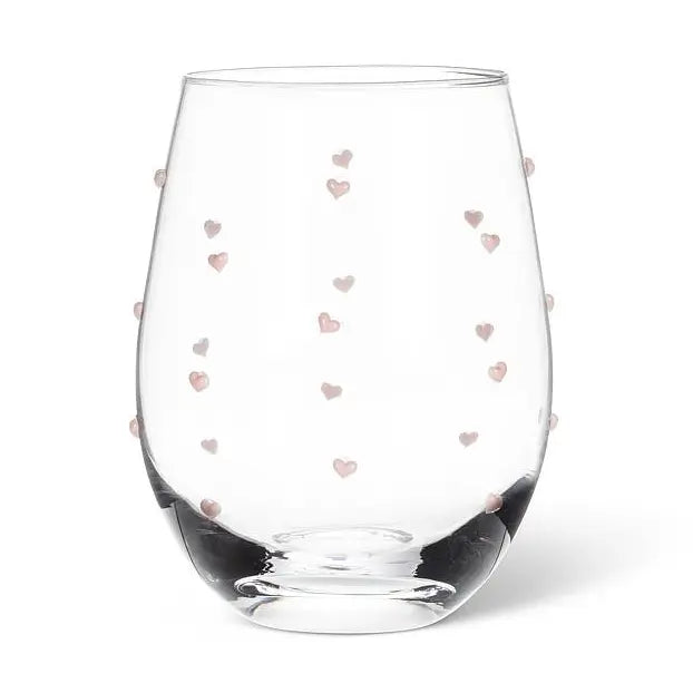 Clear stemless wine glass with tiny pink heart patterns on a white background