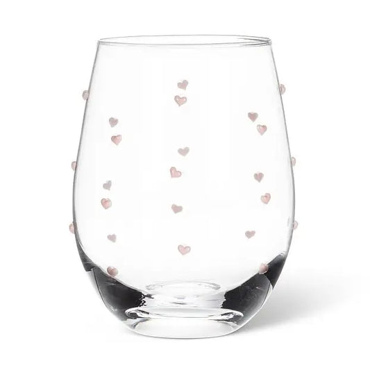 Clear stemless wine glass with tiny pink heart patterns on a white background