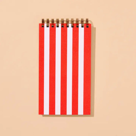 Small spiral notebook with red and white vertical stripes.