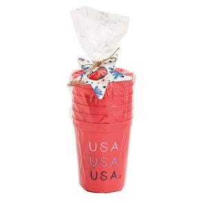six red plastic party cups with USA printed in white, grey and blue in a clear cello bag tied with a metal star shaped bottle opener and twine