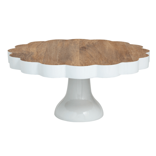 Wooden cake stand with white scalloped edge on a white pedestal base
