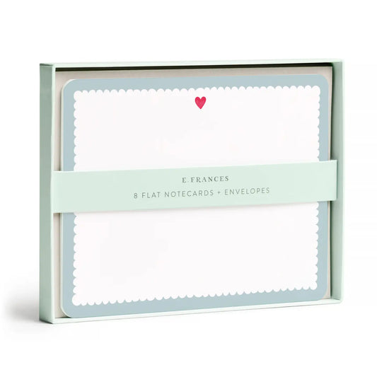 E. Frances flat notecards and envelopes set in a mint green box, featuring white scalloped-edge notecards with a small pink heart and a mint green paper band across the front.