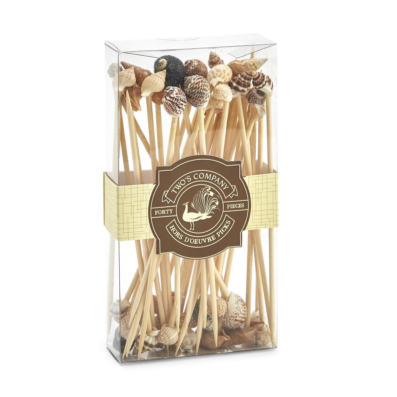 Wooden Tooth picks that have brown, black, and white seashells on the top