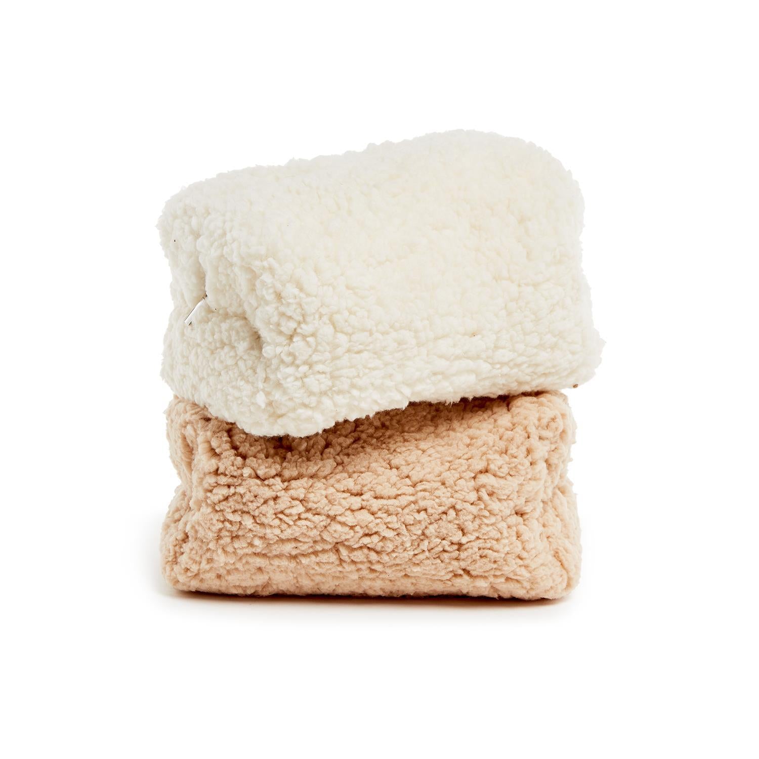Two sherpa make-up bags, one white and one beige, on a white background.