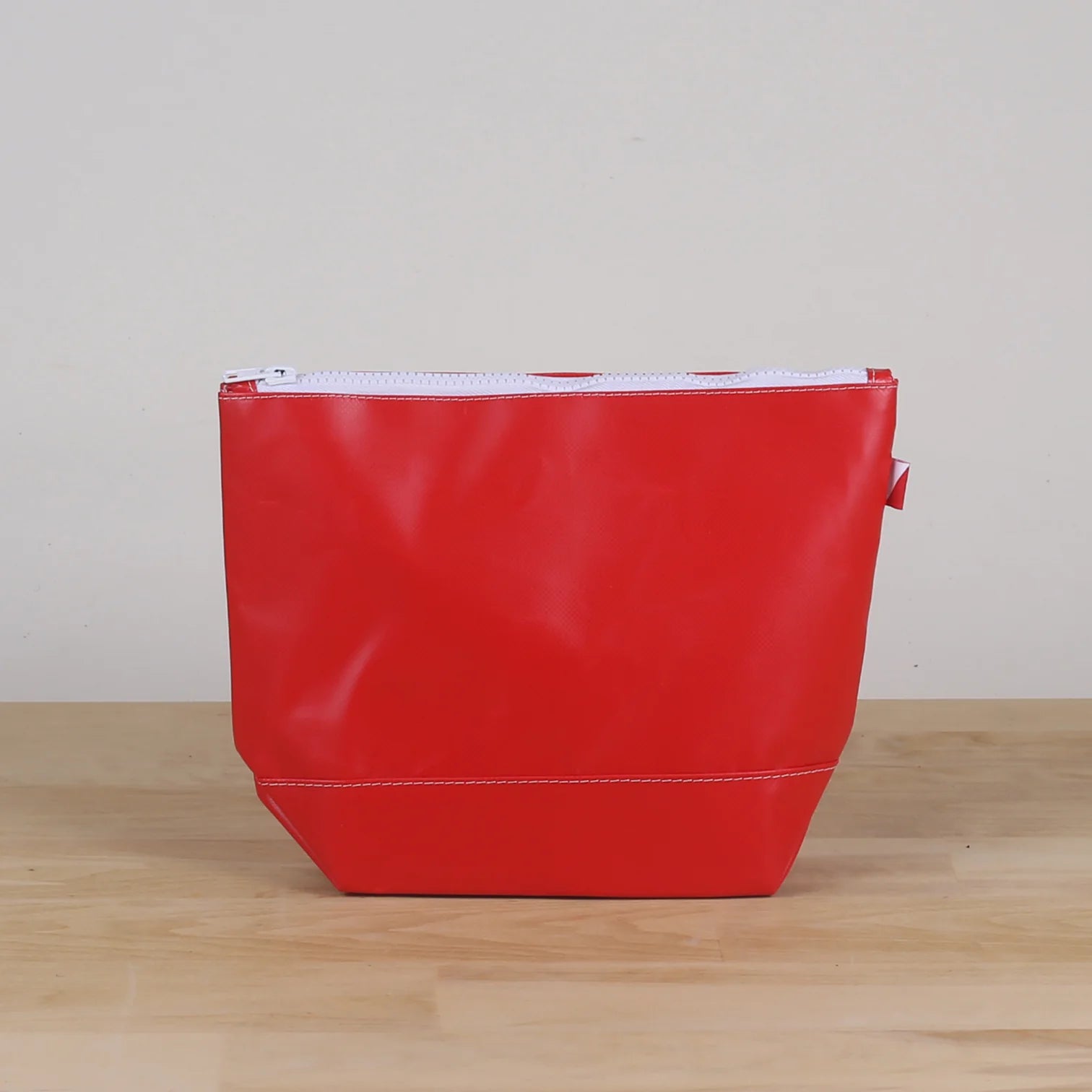 Red Pouch with water resistant material.  White zipper