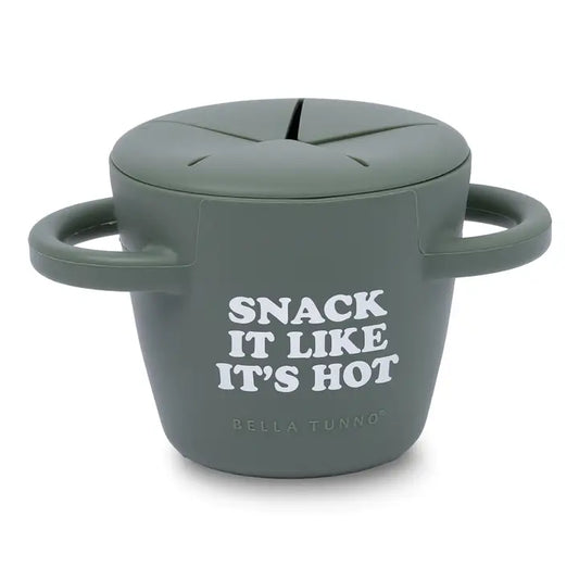 A gray food grade silicone snack cup with a lid, featuring the text 'SNACK IT LIKE IT'S HOT' and 'BELLA TUNNO' printed on the front