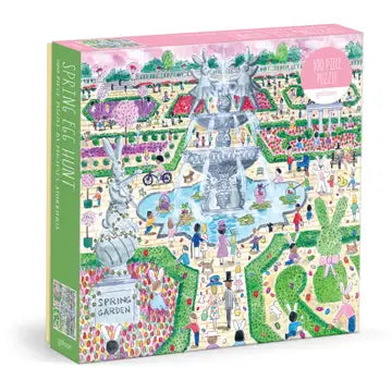 500-piece puzzle by Michael Storrings,  featuring meticulously manicured hedges, spring blooms, and ornamental topiaries framing a whimsical Easter celebration. A bunny fountain anchors the scene, surrounded by graceful statuary and hidden eggs throughout the composition.