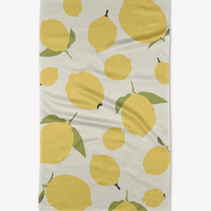 White background.  Large and small lemons with green leaves