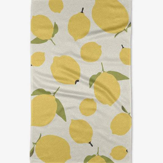 White background.  Large and small lemons with green leaves