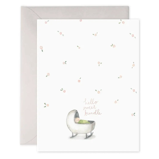 Baby greeting card that reads "Hello sweet bundle' in pink with an illustration of a baby in a cradle and light pink roses scattered throughout