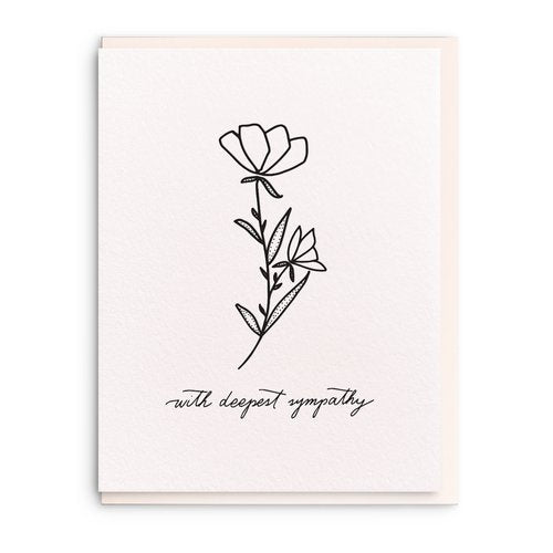 White sympathy card that has a black flower in the middle with black cursive writing under it