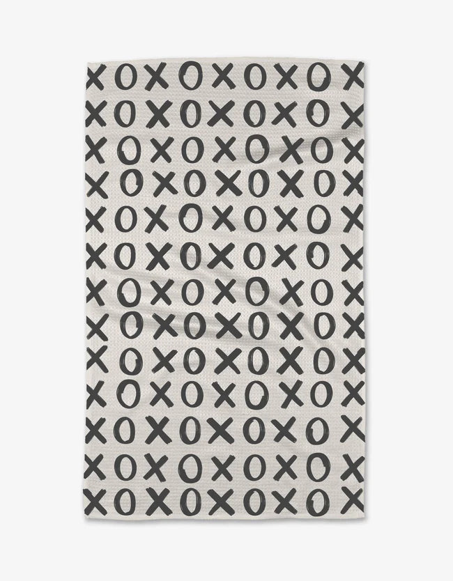 White kitchen towel with black x and o repeat pattern