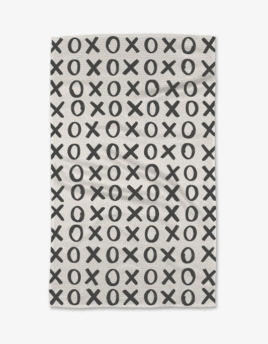 White kitchen towel with black x and o repeat pattern