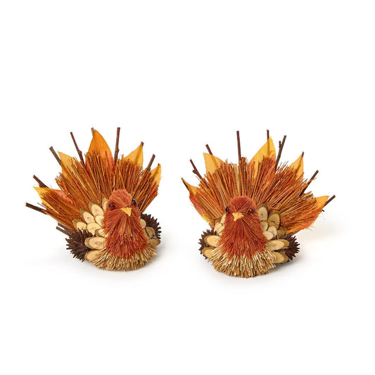Two decorative turkey placeholders with a variety of brown color feather pieces on a white background
