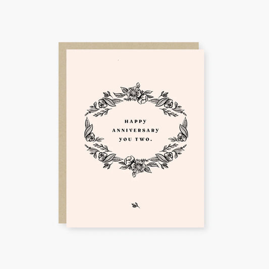 Greeting card with floral design and 'Happy Anniversary You Two' text on a light pink background