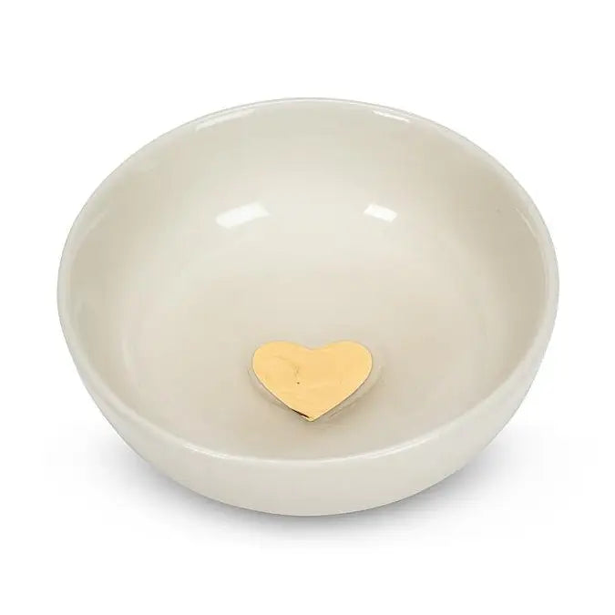 Beige ceramic bowl with a gold heart at center on a white background