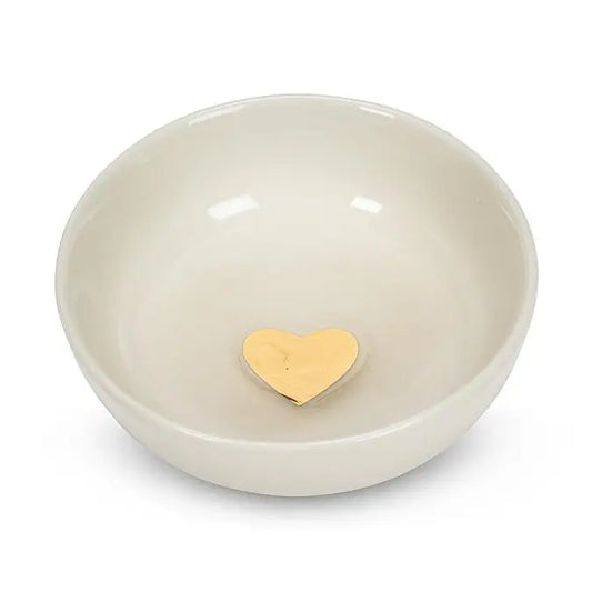 Beige ceramic bowl with a gold heart at center on a white background