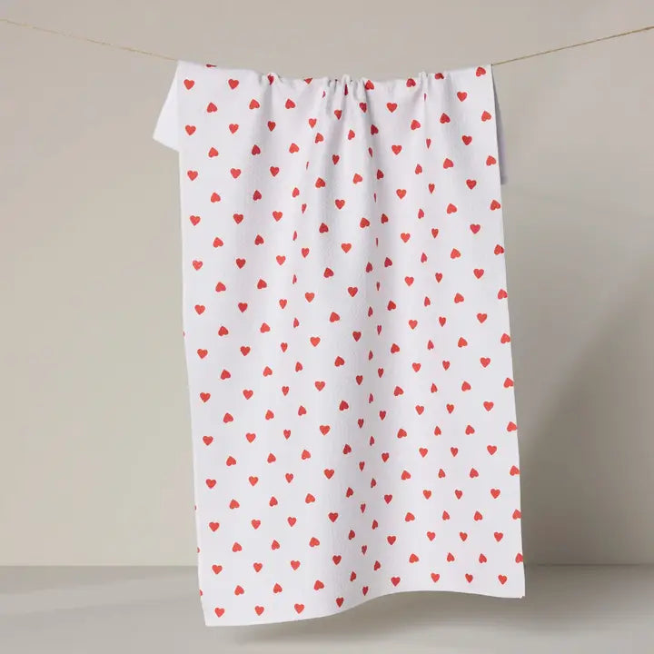 A super-absorbent, fast-drying, white kitchen towel scattered with tiny red hearts