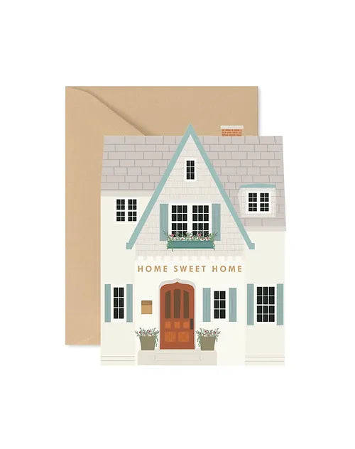 Housewarming card that has a cute house on the front with gold words in the middle