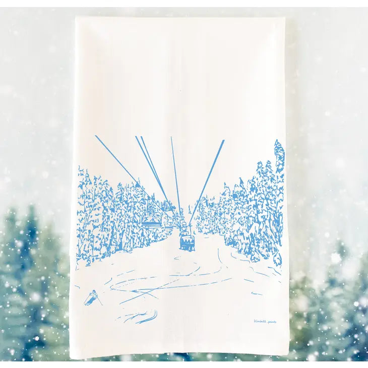 white tea towel with blue image of ski lift in the trees