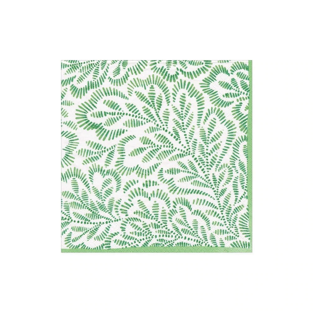 white cocktail napkin with image of fern style leaves in green