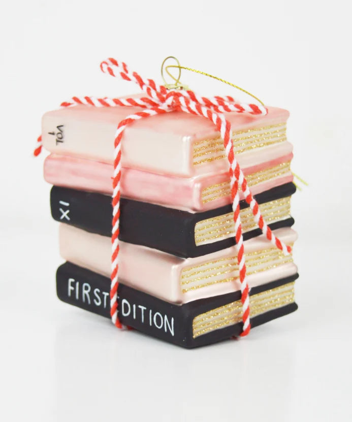 stack of pink and black books with red and white bakers ribbon around it