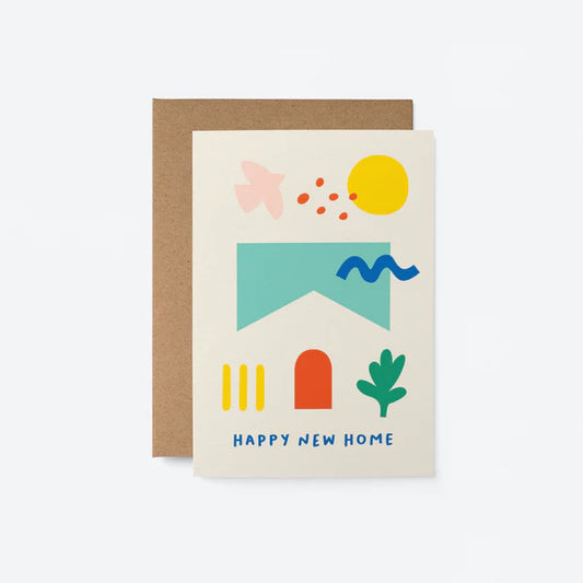 A greeting card with a colorful design, depicting a house, sun, and rainbow with the text 'HAPPY NEW HOME' on the front, enclosed in a brown eco-friendly envelope.