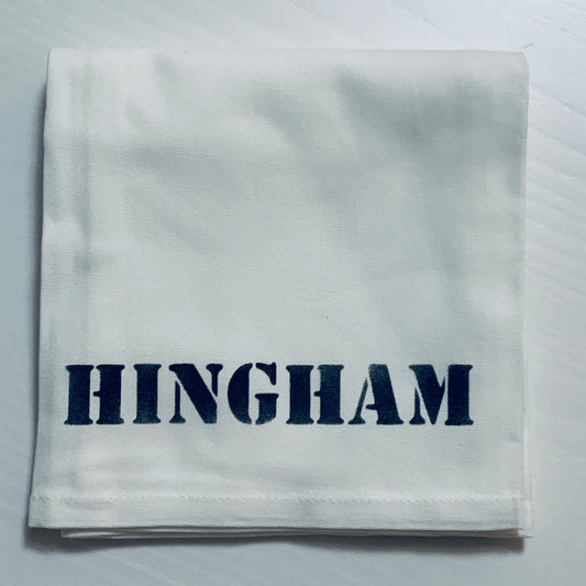 Hingham Tea towel that is white with navy blue writing