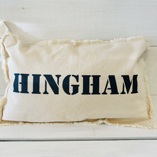 white pillow with higham on it in navy