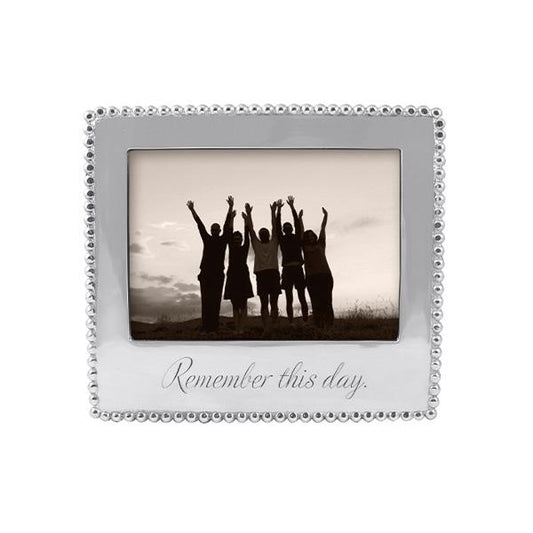 Silver frame with beaded edge.  Words Remember this day are engraved in bottom center in a script font