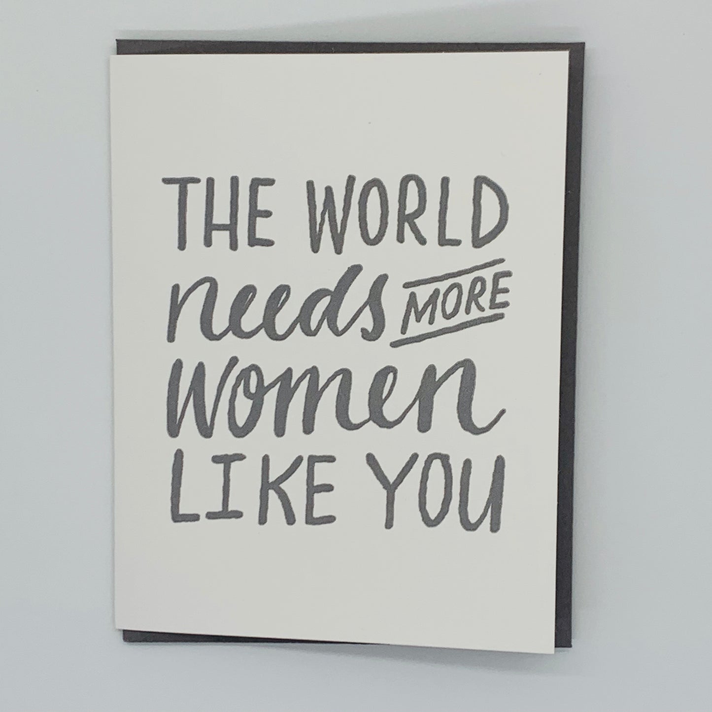 White Greeting Card with the text 'The World Needs More Women Like You' with gray envelope