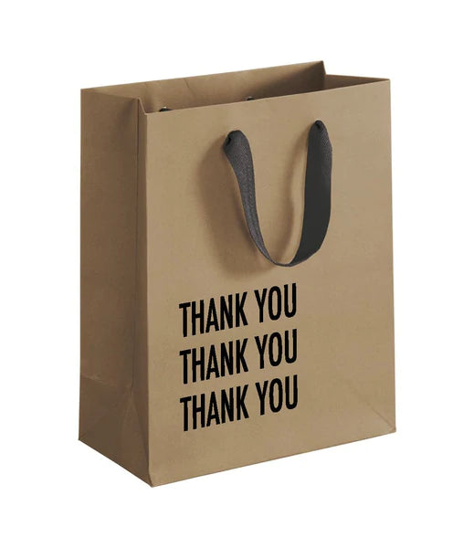 Brown gift bag that has black strings and 3 "Thank you" sayings written in black in the bottom left corner