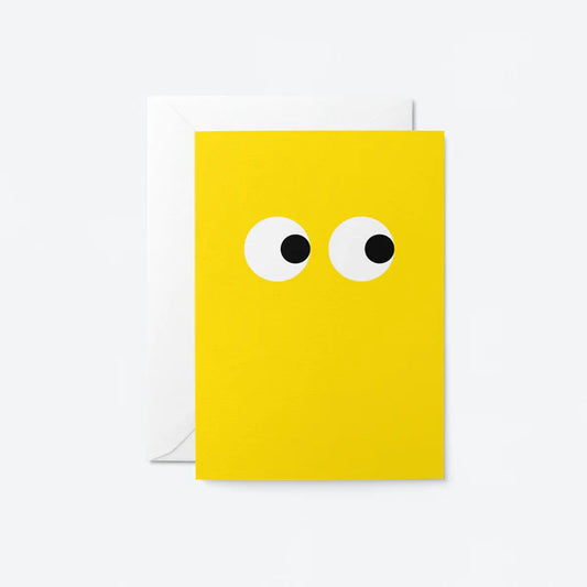 Bright yellow greeting card with eyes looking to the side