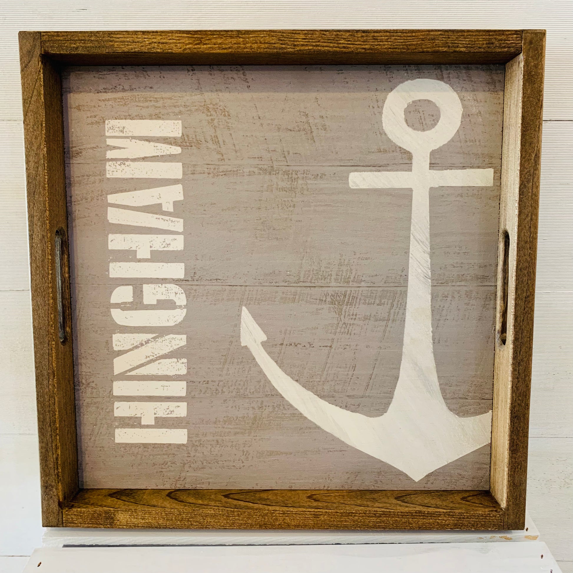 square wooden tray with gray background the word HINGHAM vertical on left and an anchor on right