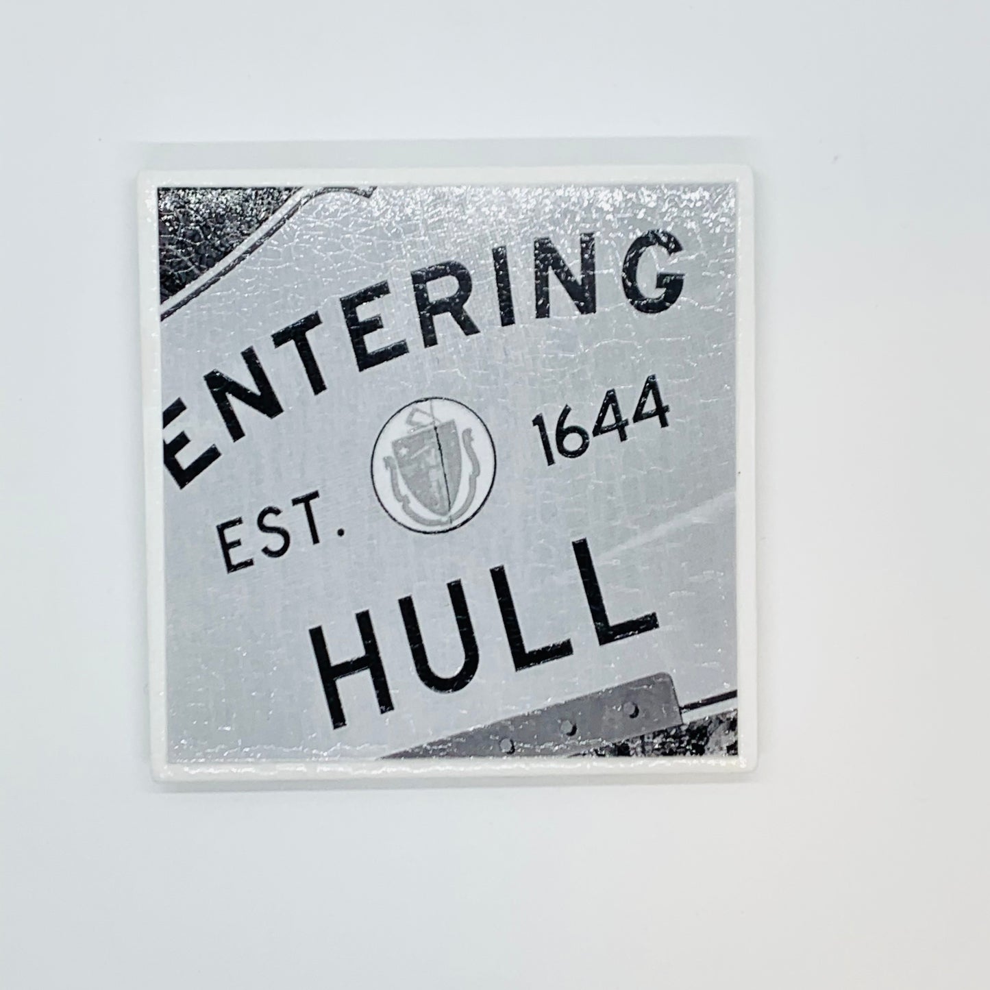 Coaster with black and white photo of the historic entering hull sign