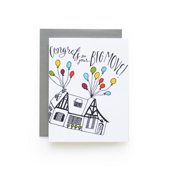 White greeting card with a sketch of a house being lifted off the ground by colorful balloons and the text "Congrats on Your Big Move!"